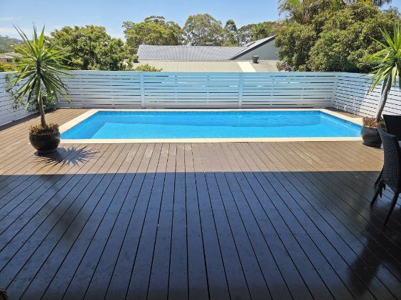 A backyard pool freshly repainted, ready to fill