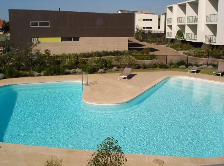 A freeform swimming pool brought back to a clean, even blue